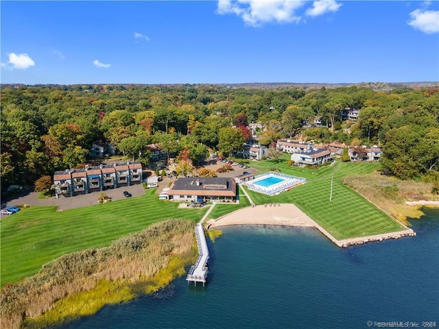 drone / aerial view featuring a water view and a forest view