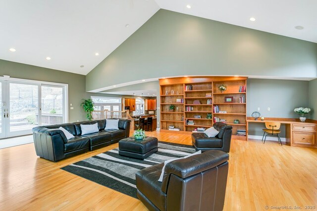 32 Village Dr, East Lyme, CT 06333 - living area featuring high vaulted ceiling, light wood finished floors, and recessed lighting