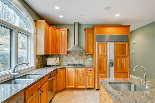 32 Village Dr, East Lyme, CT 06333 - kitchen with wall chimney exhaust hood, a sink, backsplash, recessed lighting, and light stone counters