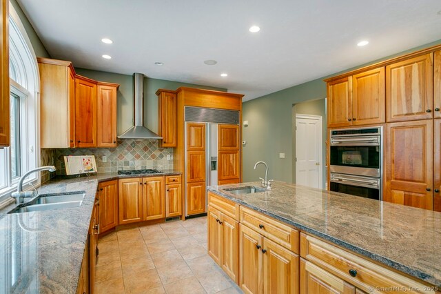32 Village Dr, East Lyme, CT 06333 - kitchen with a sink, double oven, paneled fridge, wall chimney range hood, and recessed lighting