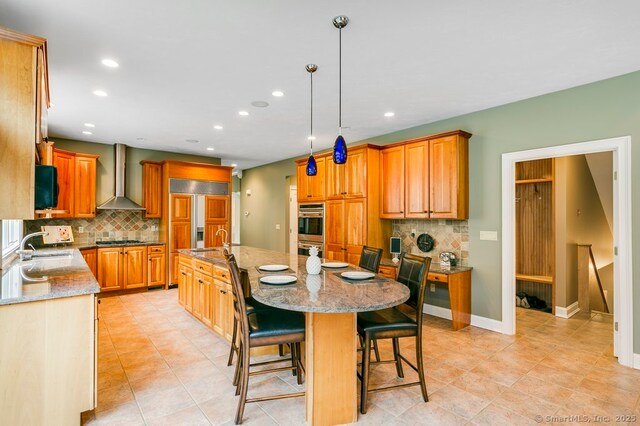 32 Village Dr, East Lyme, CT 06333 - kitchen with wall chimney range hood, a sink, a large island, tasteful backsplash, and stainless steel double oven