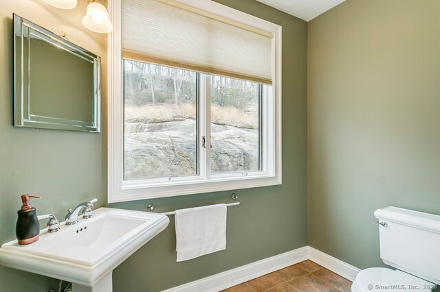 32 Village Dr, East Lyme, CT 06333 - half bath featuring toilet, a sink, baseboards, and tile patterned flooring