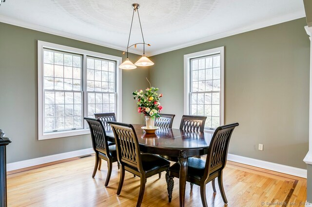 32 Village Dr, East Lyme, CT 06333 - dining space with plenty of natural light, light wood finished floors, ornamental molding, and baseboards