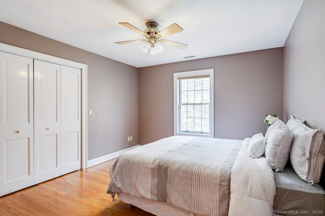 32 Village Dr, East Lyme, CT 06333 - bedroom with a closet, light wood-style floors, ceiling fan, and baseboards