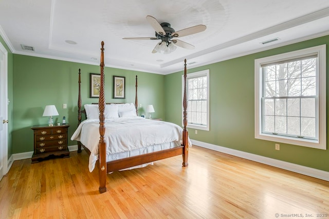 32 Village Dr, East Lyme, CT 06333 - bedroom with light wood-style floors, baseboards, a raised ceiling, crown molding, and a ceiling fan