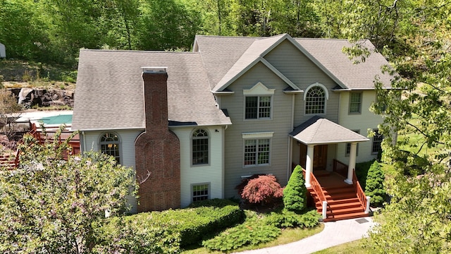 32 Village Dr, East Lyme, CT 06333 - view of front facade with a chimney and a shingled roof