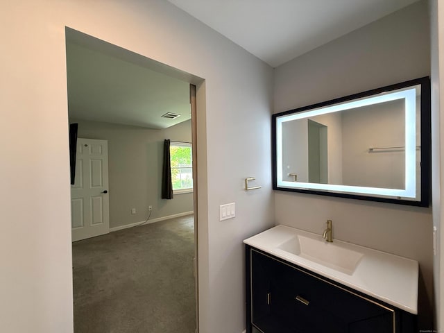 bathroom featuring baseboards and vanity