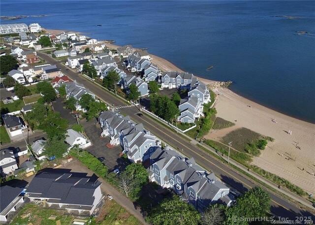 aerial view of property's location featuring nearby suburban area and a nearby body of water