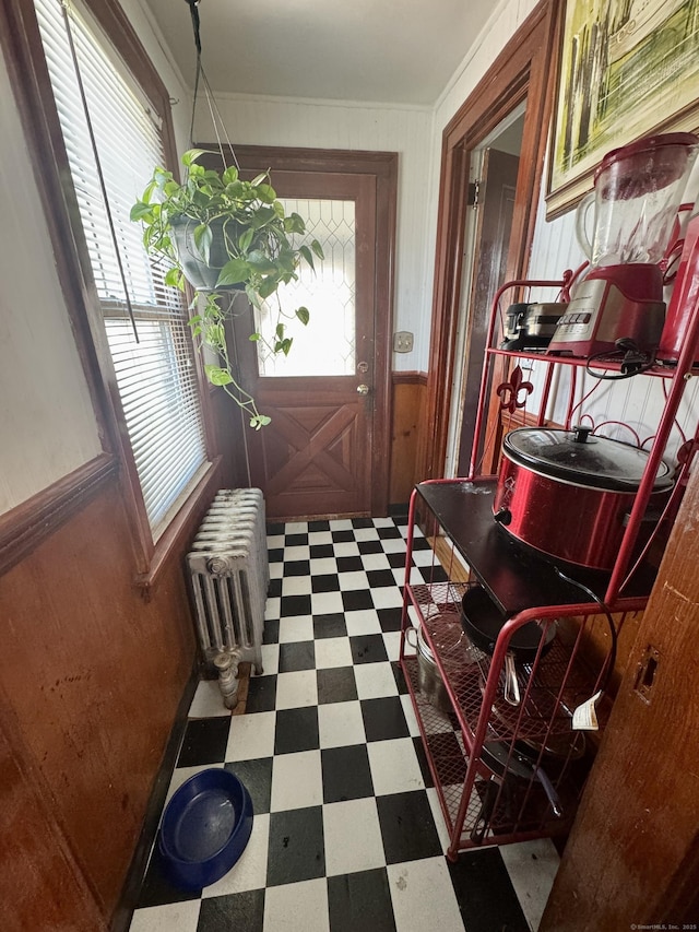 572 Forbes St, East Hartford, CT 06118 - entryway featuring ornamental molding, wainscoting, radiator heating unit, wooden walls, and tile patterned floors
