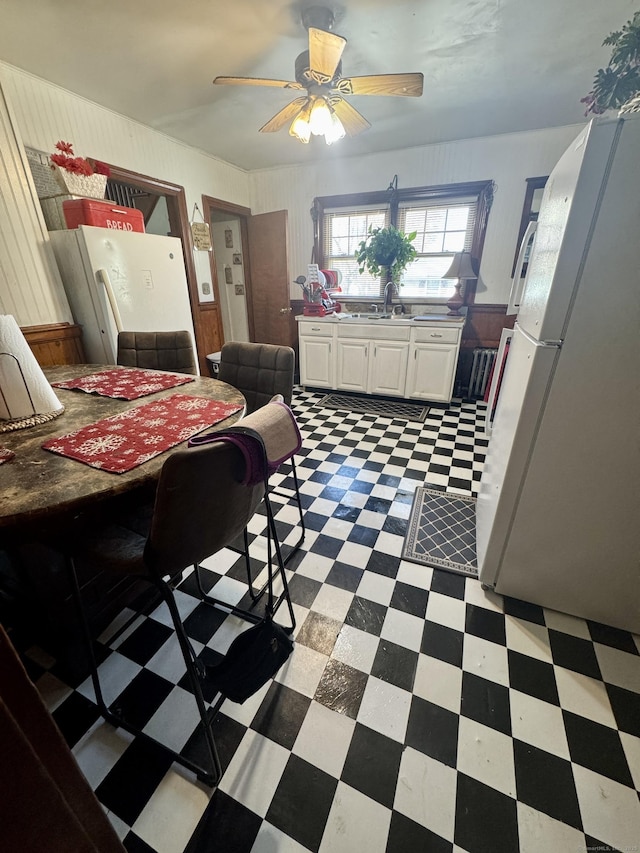 572 Forbes St, East Hartford, CT 06118 - dining room featuring a ceiling fan, tile patterned floors, and wood walls