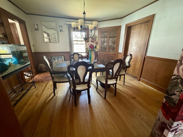 572 Forbes St, East Hartford, CT 06118 - dining room with an inviting chandelier, ornamental molding, and a wainscoted wall