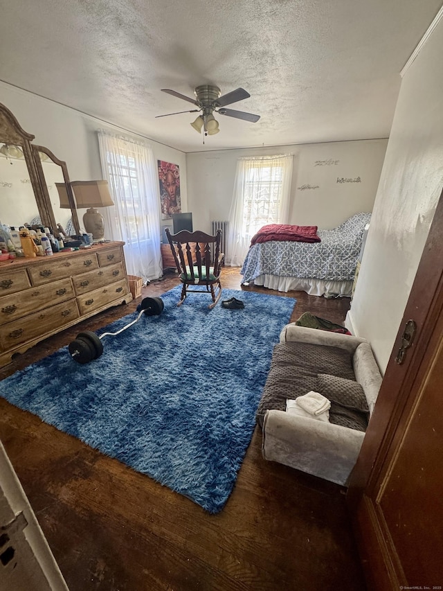 572 Forbes St, East Hartford, CT 06118 - bedroom with ceiling fan, a textured ceiling, and wood finished floors