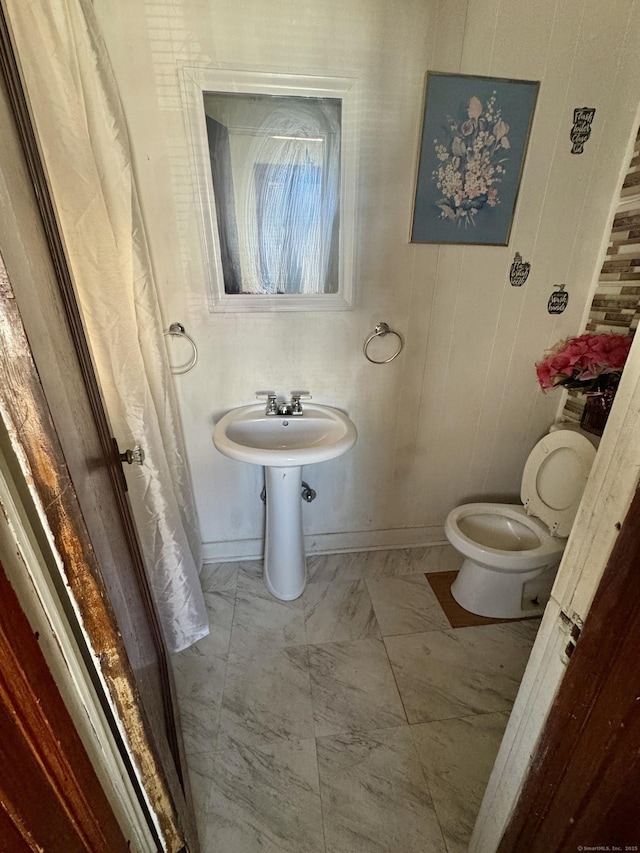 572 Forbes St, East Hartford, CT 06118 - bathroom with baseboards, toilet, and marble finish floor