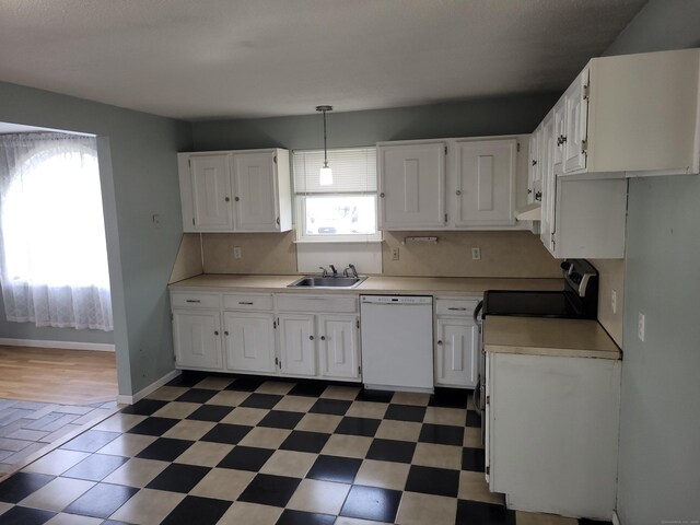 kitchen featuring dishwasher, a sink, light countertops, white cabinets, and baseboards