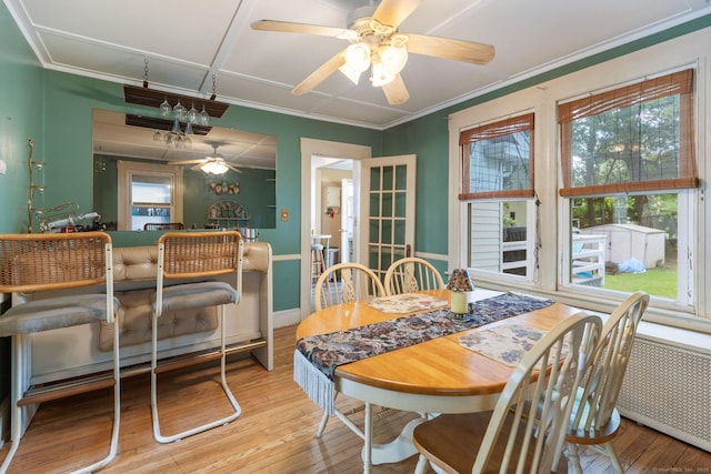 dining area featuring a ceiling fan, hardwood / wood-style floors, and crown molding