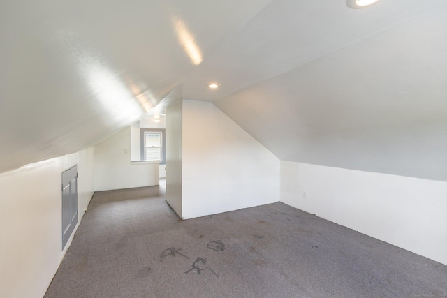 additional living space with carpet flooring and vaulted ceiling