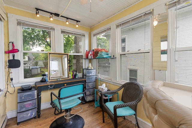 sunroom with track lighting, hardwood / wood-style flooring, and plenty of natural light