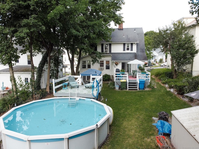view of pool featuring a deck and a yard
