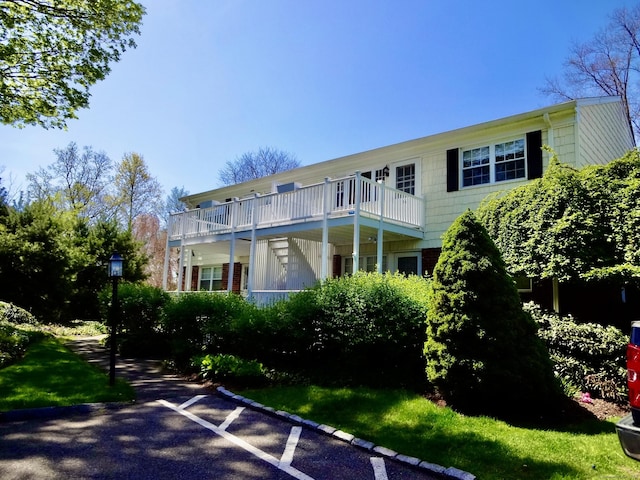 back of house featuring a balcony