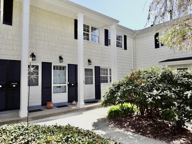 view of exterior entry with a porch