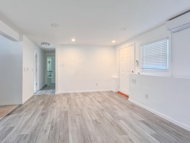 4 Robert Ln, Westport, CT 06880 - empty room featuring a wall unit AC, light wood-style flooring, and recessed lighting