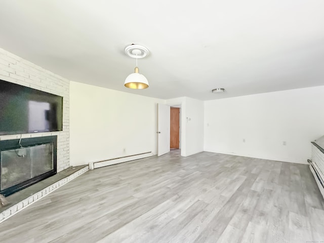 4 Robert Ln, Westport, CT 06880 - unfurnished living room featuring a baseboard heating unit, wood finished floors, and a brick fireplace