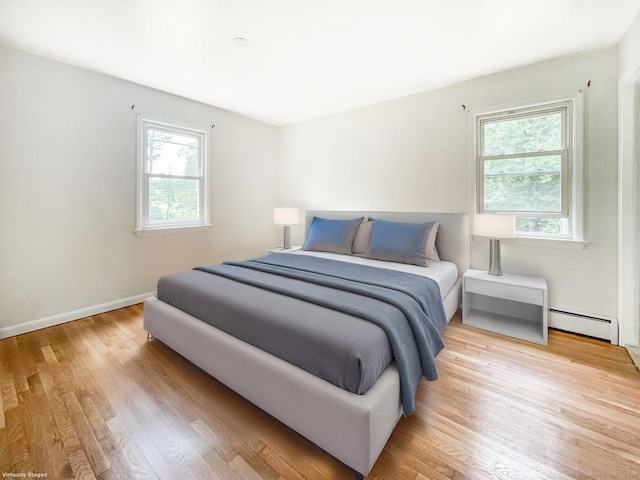4 Robert Ln, Westport, CT 06880 - bedroom featuring baseboard heating, multiple windows, and wood finished floors