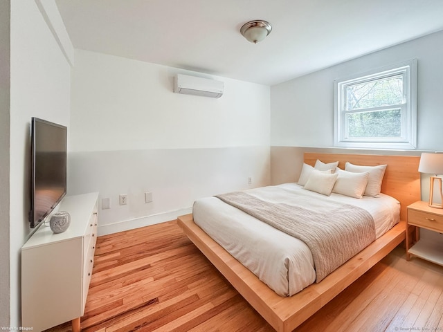 4 Robert Ln, Westport, CT 06880 - bedroom with a wall mounted air conditioner and light wood-style flooring
