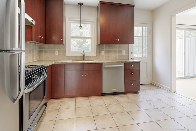 4 Robert Ln, Westport, CT 06880 - kitchen with stainless steel appliances, under cabinet range hood, backsplash, and plenty of natural light