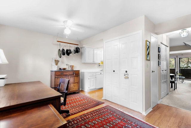 office area featuring light wood finished floors and ceiling fan