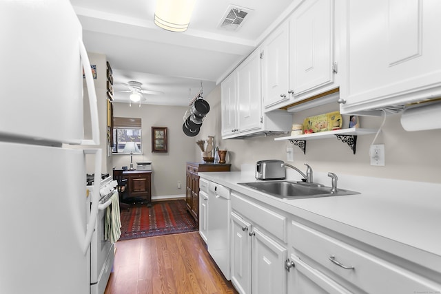 kitchen with white appliances, a sink, light countertops, a ceiling fan, and white cabinetry