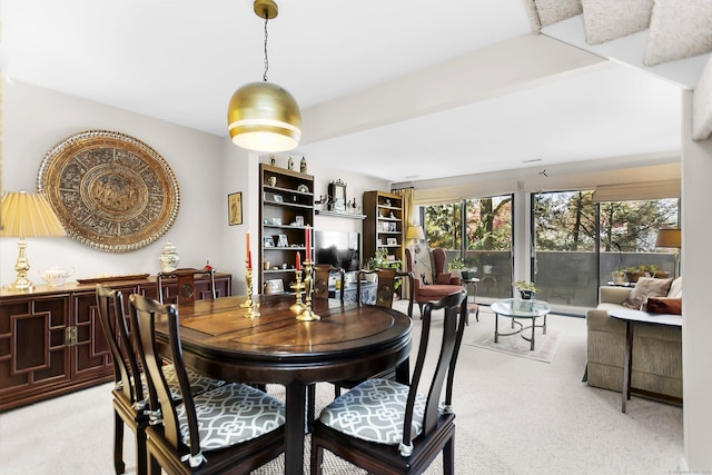 dining space featuring light colored carpet