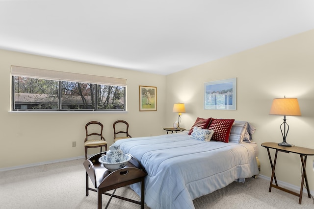carpeted bedroom featuring baseboards