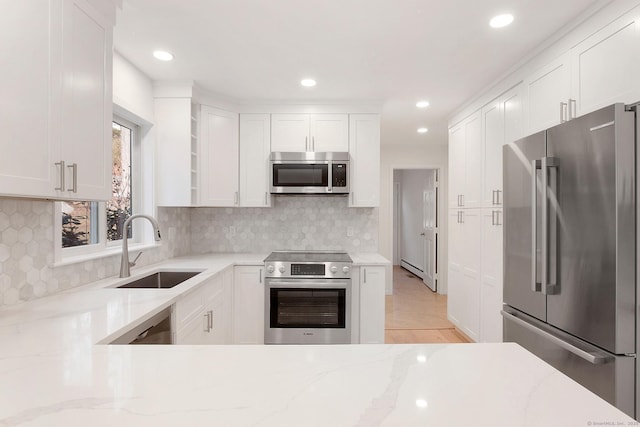 1510 Congress St, Fairfield, CT 06825 - kitchen with appliances with stainless steel finishes, light stone counters, open shelves, white cabinets, and backsplash
