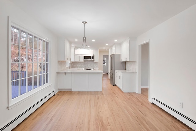 1510 Congress St, Fairfield, CT 06825 - kitchen featuring a baseboard radiator, appliances with stainless steel finishes, light countertops, light wood-style flooring, and recessed lighting