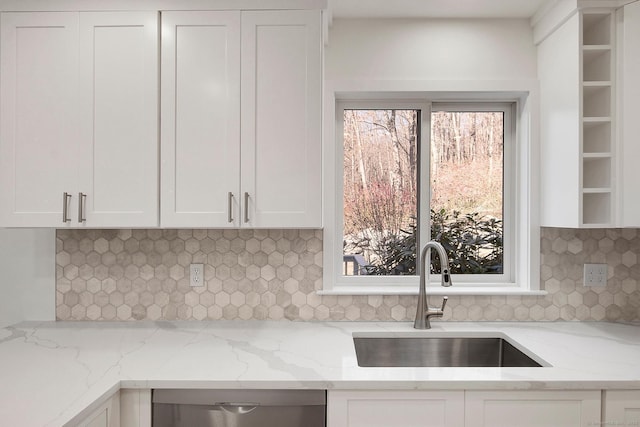 1510 Congress St, Fairfield, CT 06825 - kitchen with white cabinets, dishwasher, backsplash, and light stone countertops