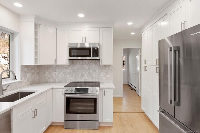 1510 Congress St, Fairfield, CT 06825 - kitchen featuring stainless steel appliances, open shelves, white cabinetry, backsplash, and recessed lighting