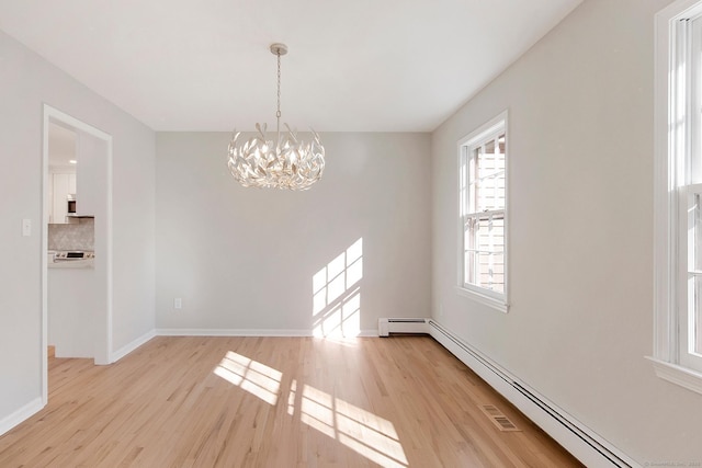 1510 Congress St, Fairfield, CT 06825 - unfurnished room with a baseboard radiator, a chandelier, and light wood-style flooring