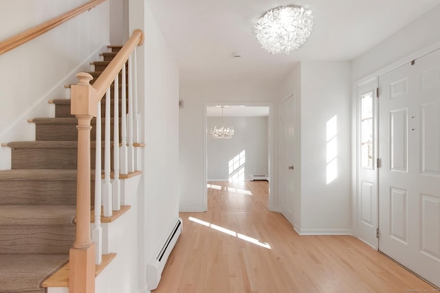 1510 Congress St, Fairfield, CT 06825 - entrance foyer featuring a baseboard heating unit, a chandelier, light wood-type flooring, and stairway