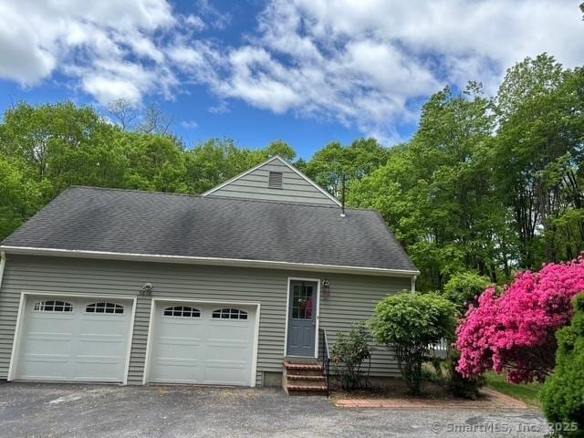 1510 Congress St, Fairfield, CT 06825 - view of property exterior with entry steps, driveway, an attached garage, and roof with shingles