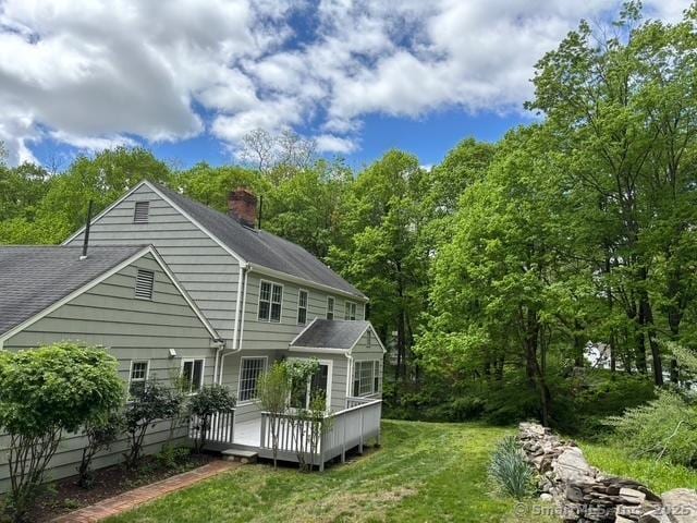 1510 Congress St, Fairfield, CT 06825 - back of property featuring a chimney, a wooden deck, and a lawn