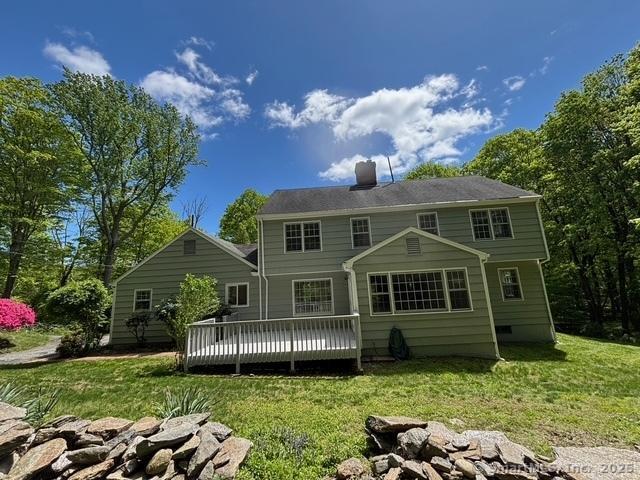 1510 Congress St, Fairfield, CT 06825 - back of property with a wooden deck, a yard, and a chimney