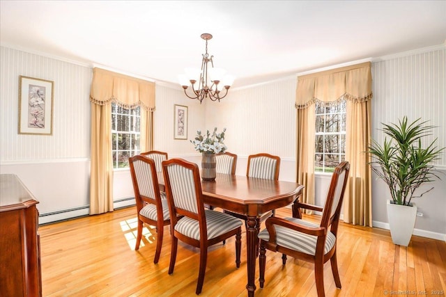 dining room featuring crown molding, an inviting chandelier, and a baseboard heating unit