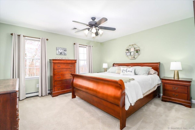 bedroom with baseboard heating, ceiling fan, light carpet, and visible vents