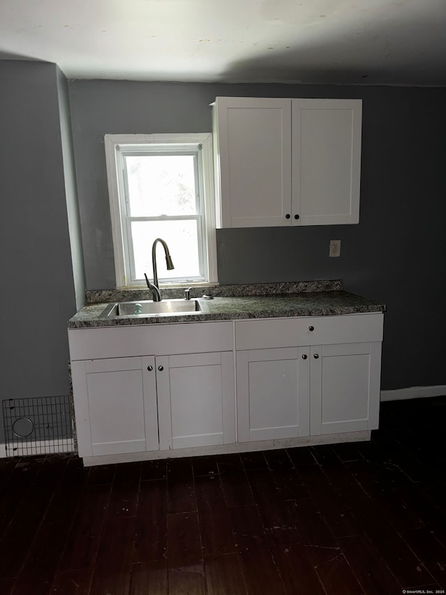 254 Starr St, New Haven, CT 06511 - kitchen with dark wood-type flooring and white cabinets