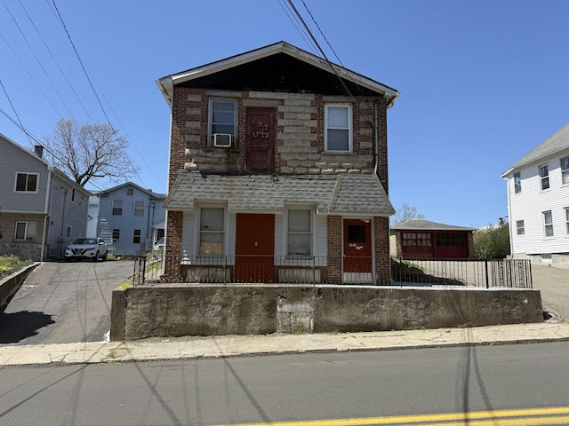 multi unit property with a fenced front yard and brick siding