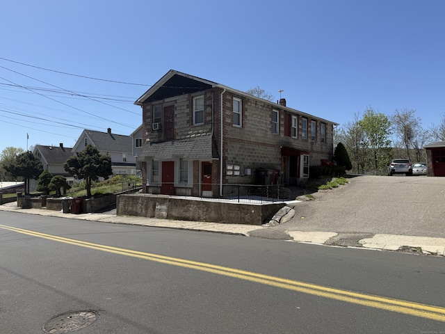view of property featuring brick siding and a chimney