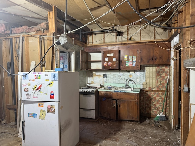 kitchen with white appliances, a sink, and light countertops