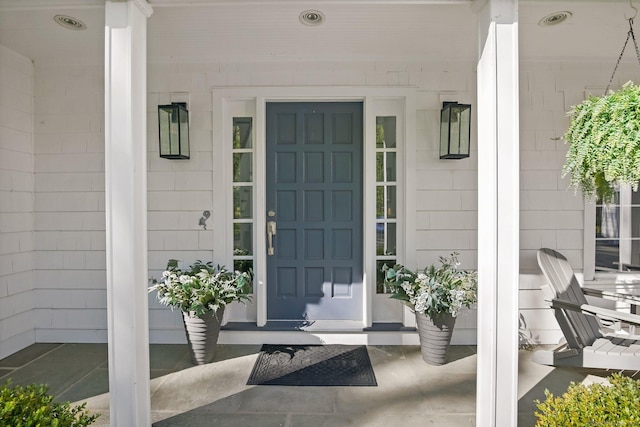 view of exterior entry featuring a porch