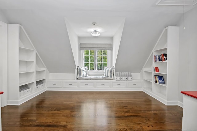 bonus room featuring built in features, dark wood finished floors, and vaulted ceiling